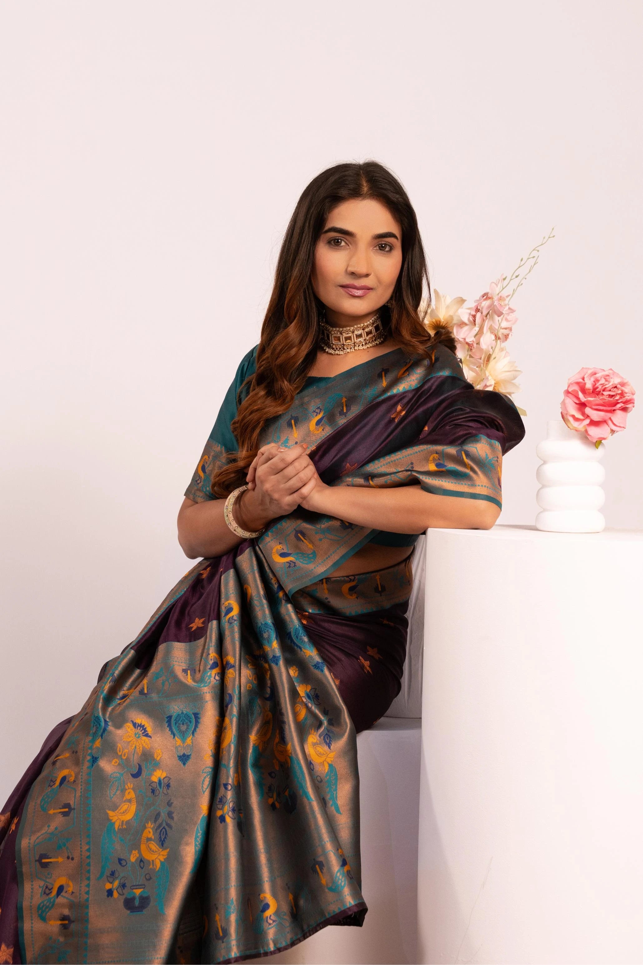 Woman wearing a traditional saree with a white background