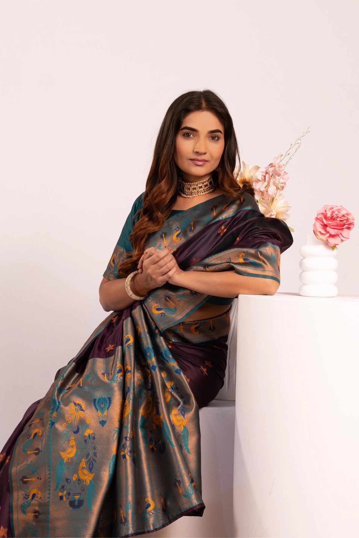 Woman wearing a traditional saree with a white background