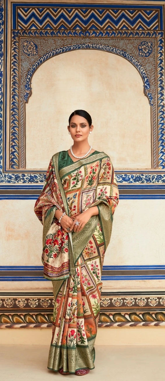 Woman in a traditional saree standing in front of an ornate wall.