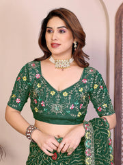 Woman wearing a green embroidered traditional outfit with a neutral background