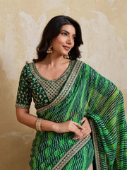 Woman wearing a green saree with a textured background