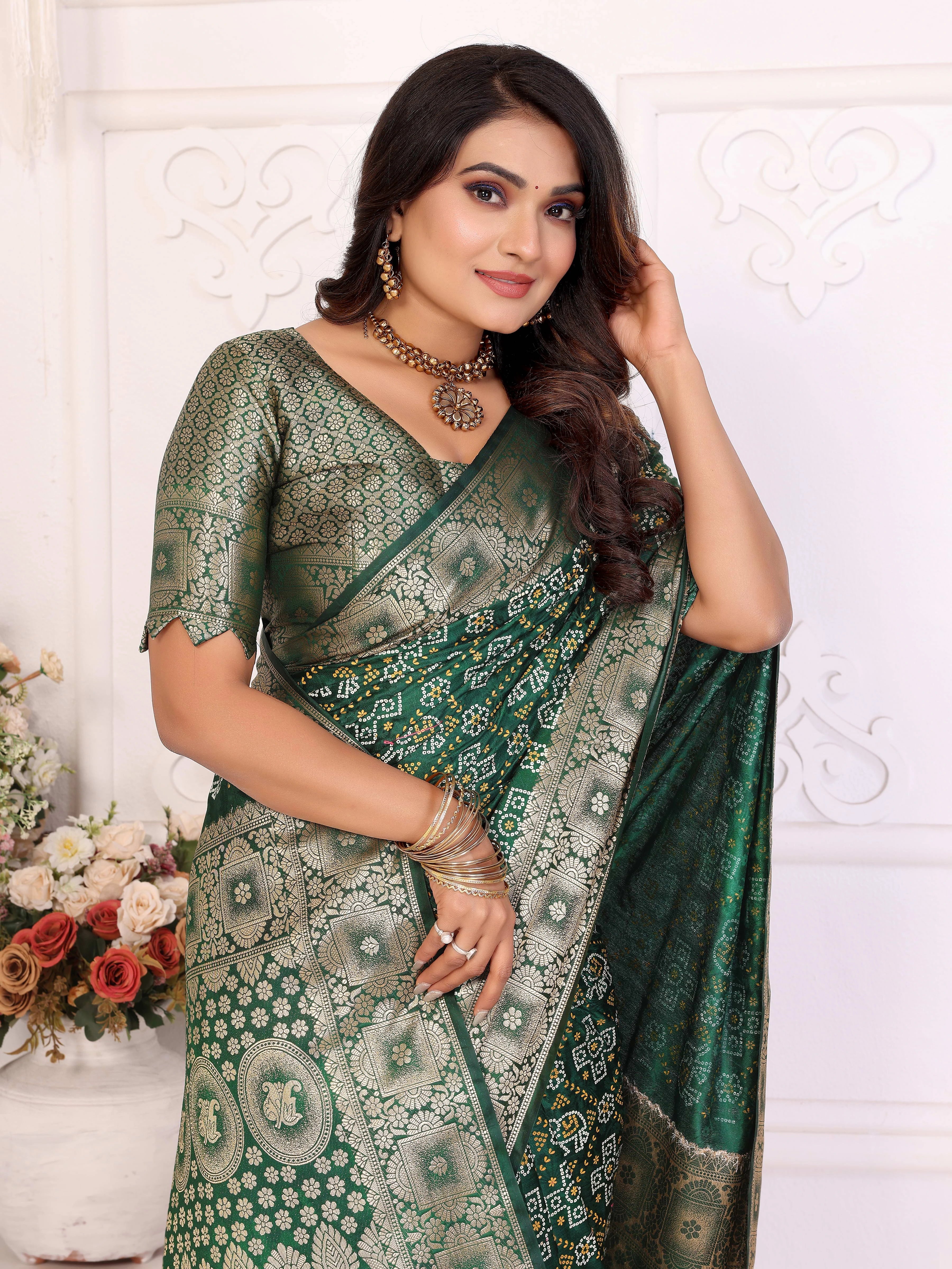 Woman wearing a green saree with a white floral background