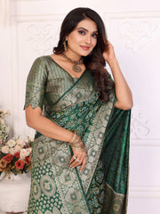 Woman wearing a green saree with a white floral background