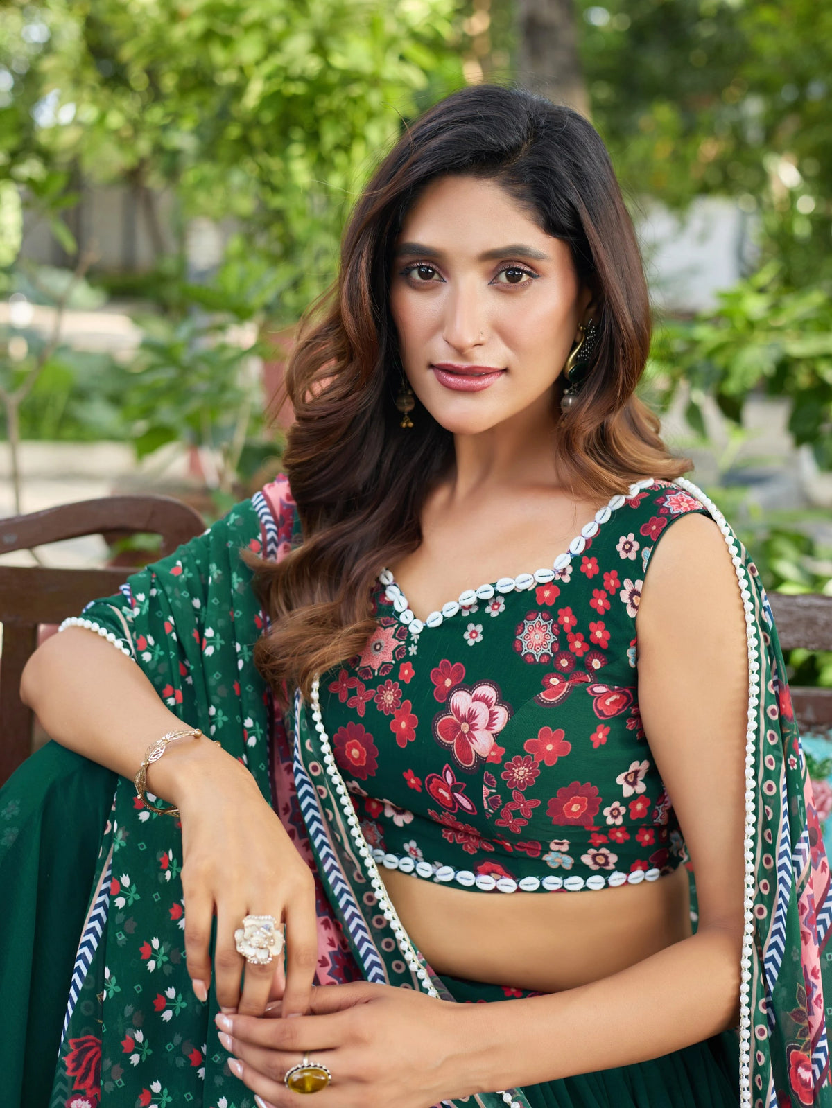 Woman wearing a floral blouse with a green background