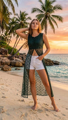 Woman standing on a beach with palm trees and sunset in the background