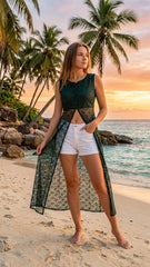 Woman standing on a beach with palm trees and sunset in the background