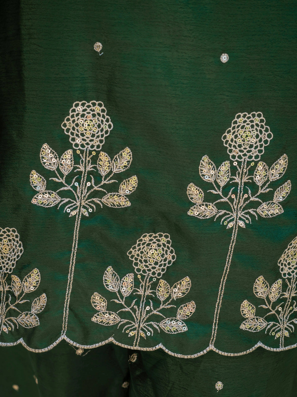 Green fabric with white floral embroidery