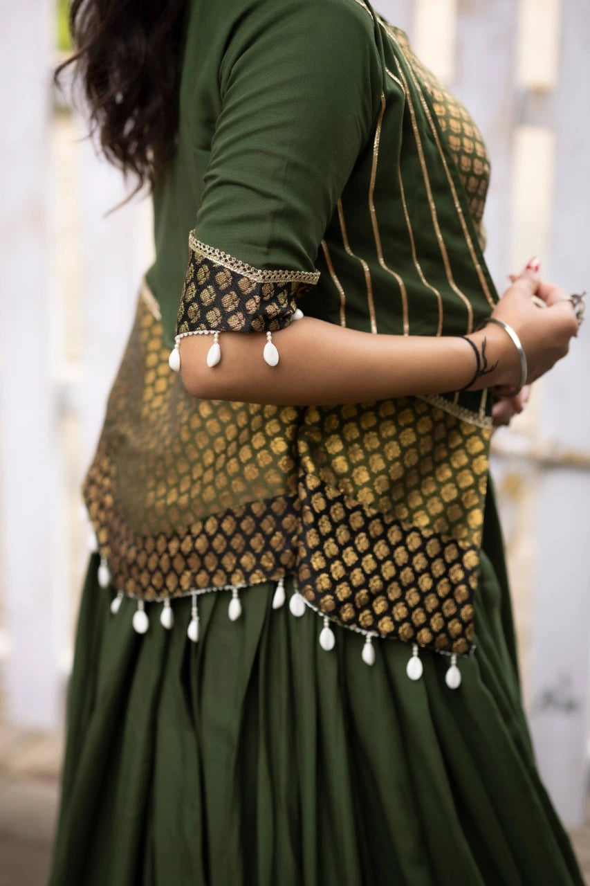 Green traditional outfit with gold and black embroidered blouse