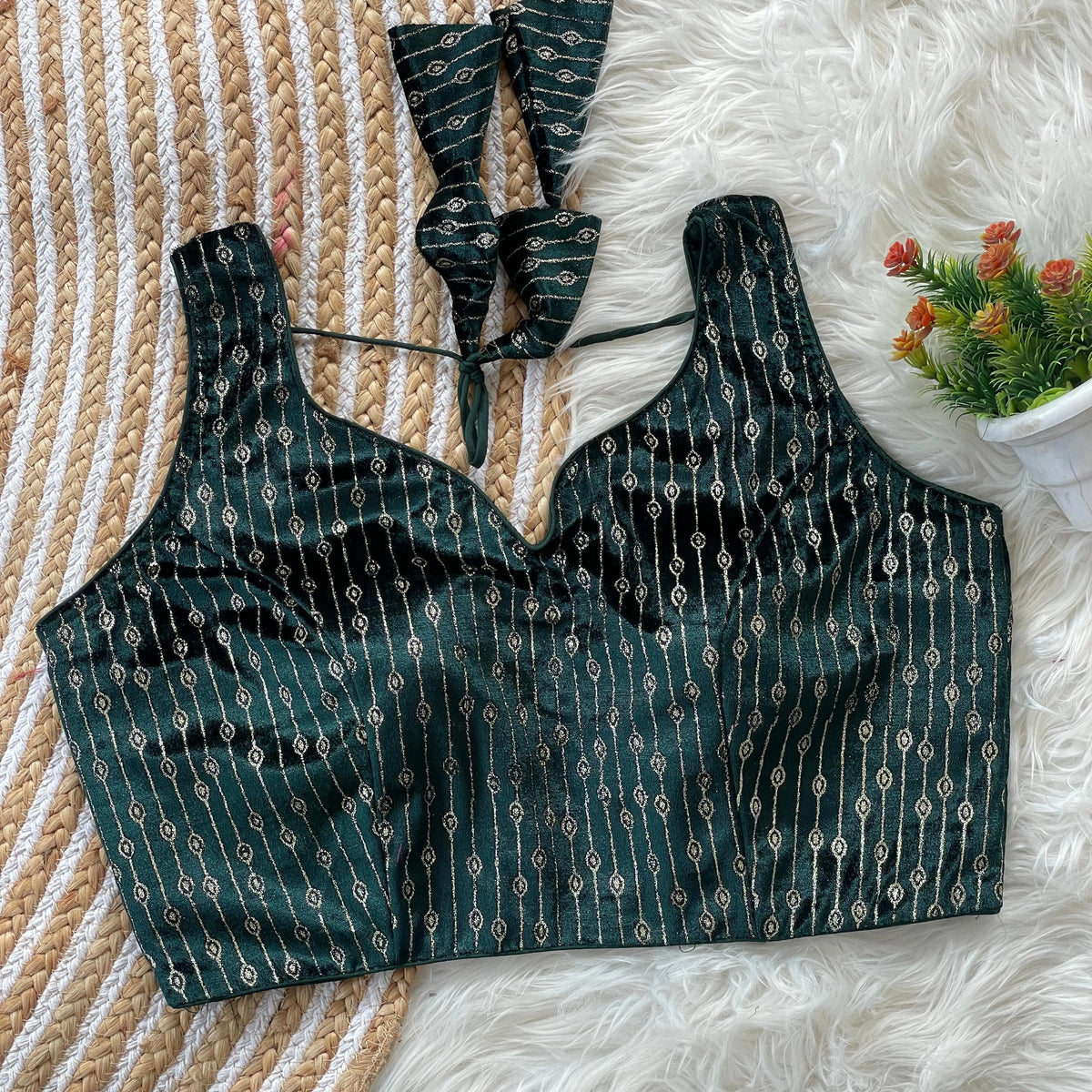 Green patterned top on a textured surface with a blurred background