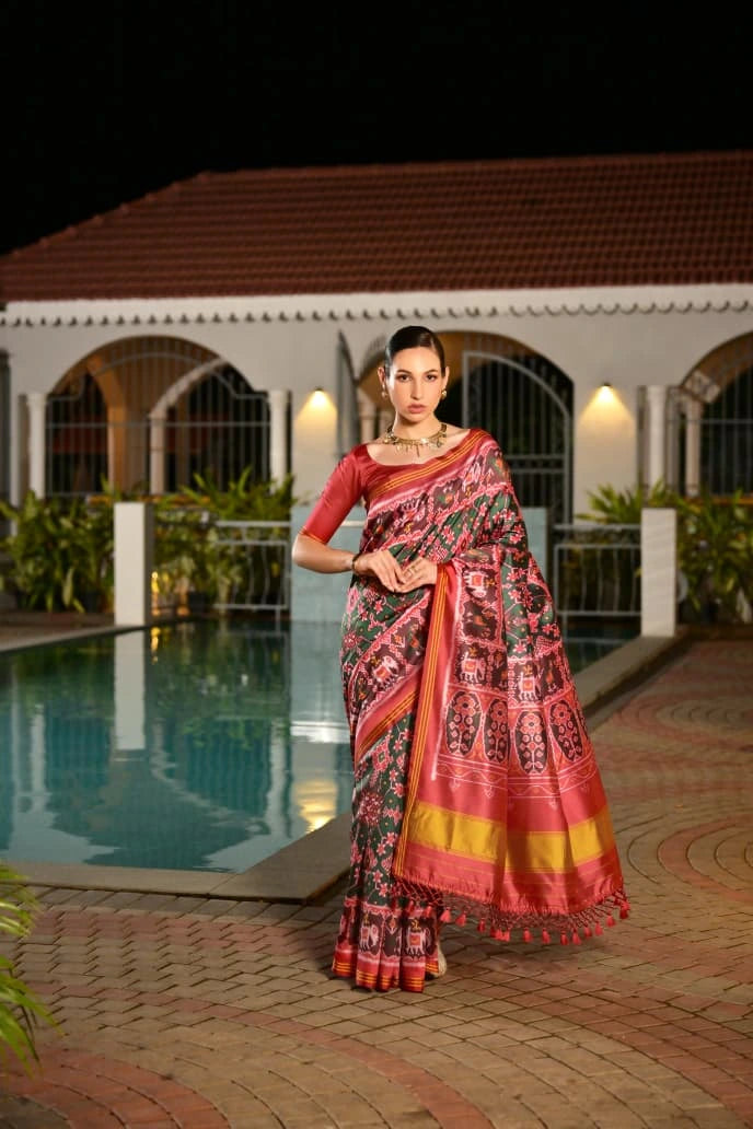 Dark green Patola silk saree with traditional Ikkat print displayed on Shopify product page