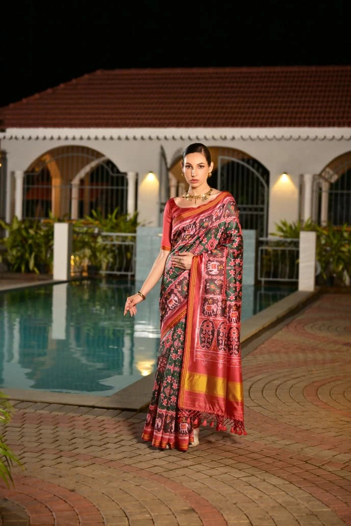 Elegant handcrafted soft silk saree in dark green featuring geometric Ikkat design