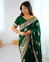 Woman wearing a green saree with a white background