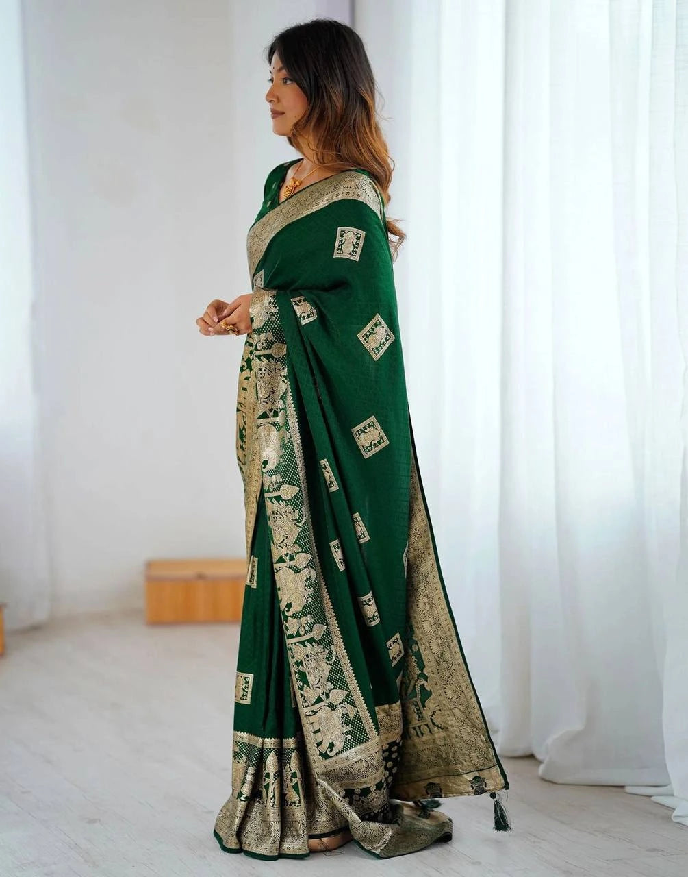 Woman wearing a green saree with a white background