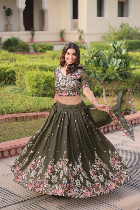 Woman in a floral and embroidered lehenga standing in a garden setting