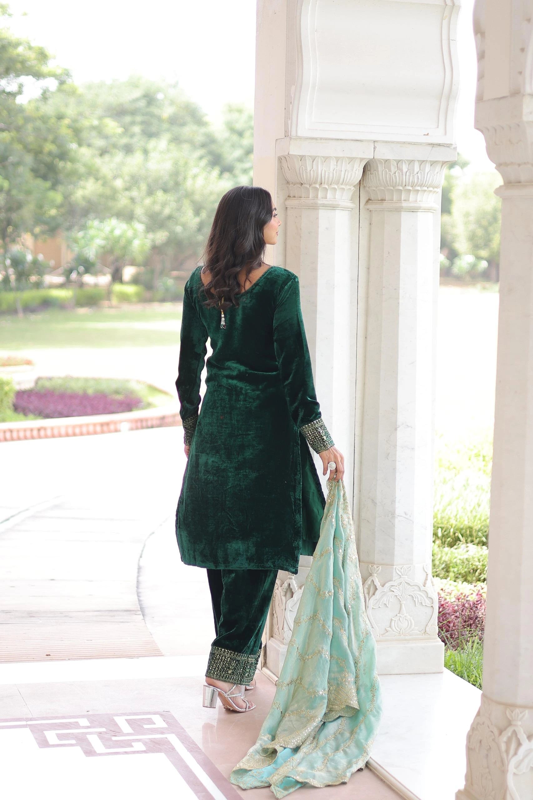 Festive navy velvet ethnic suit featuring heavy front embroidery, matching pants, and a light blue embellished dupatta.