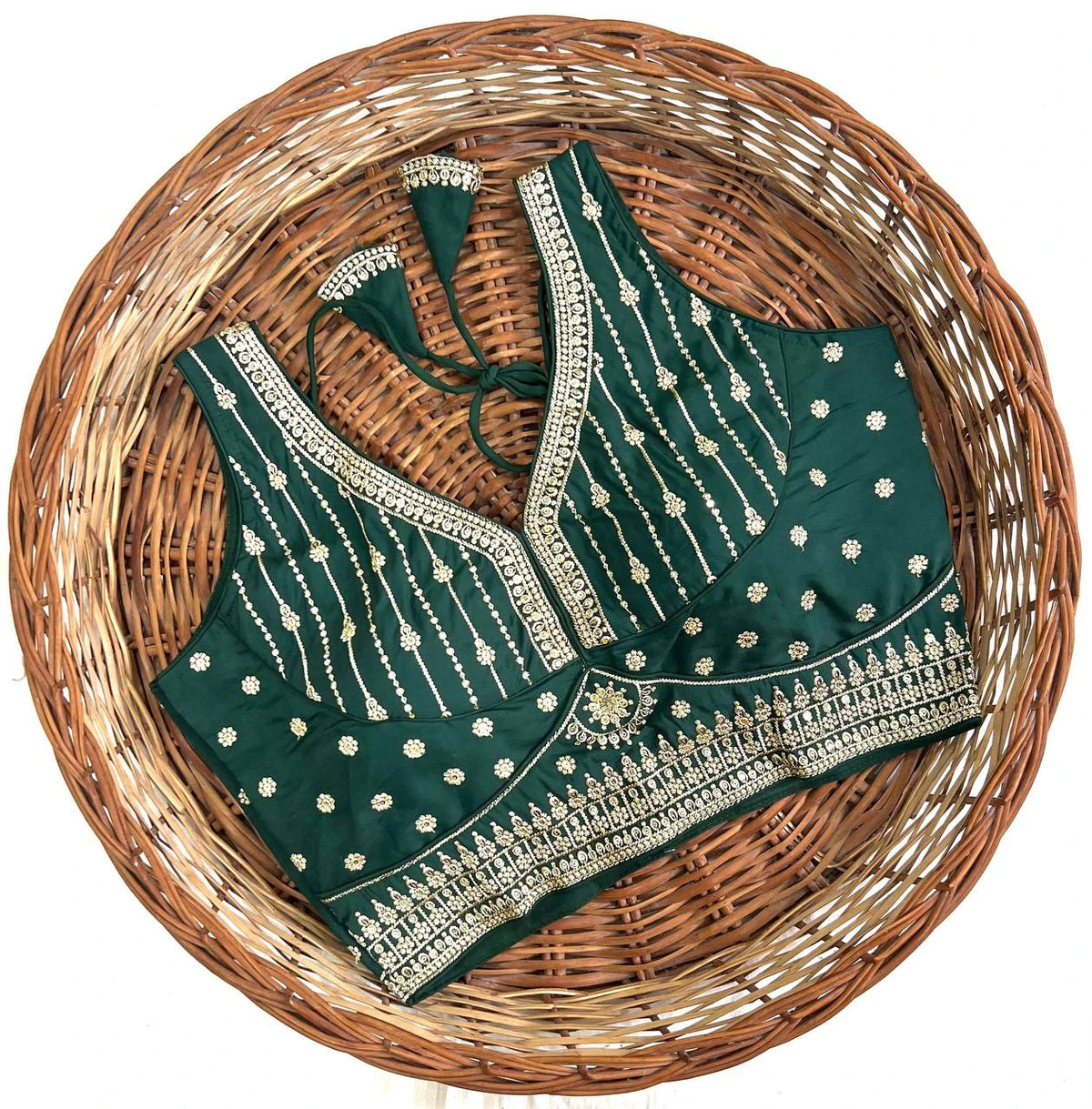 Green embroidered blouse on a woven basket