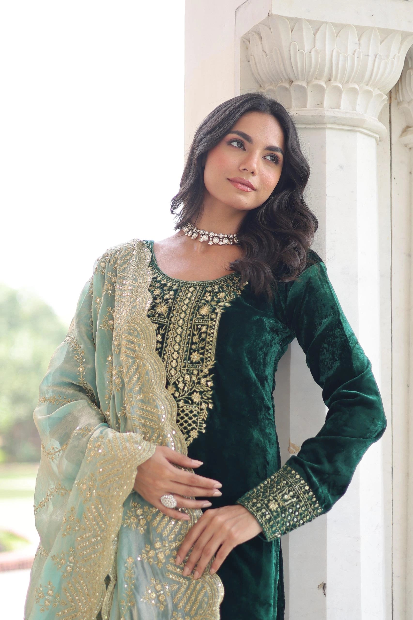 Elegant velvet suit in deep blue shade with detailed embroidery and a soft shimmering dupatta, styled for a graceful festive look.