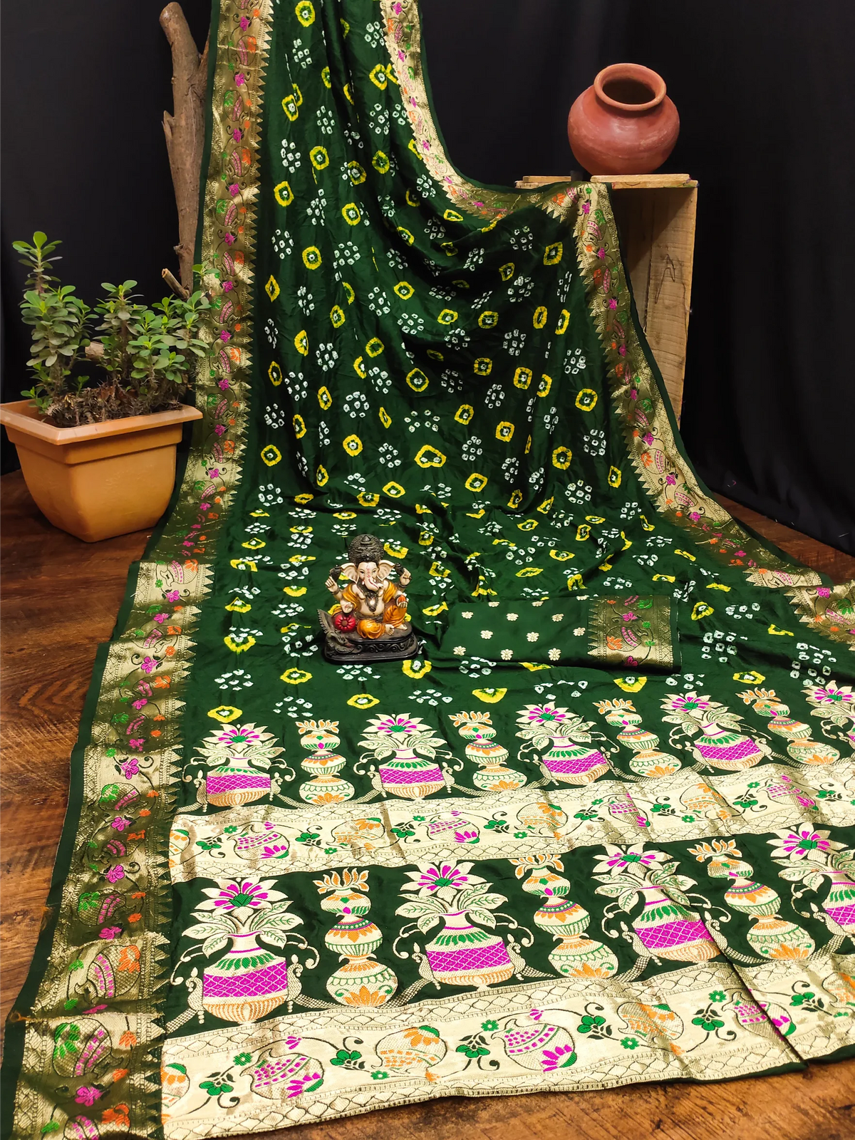 Green and white patterned fabric with decorative elements on a wooden surface.