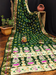 Green and white patterned fabric with decorative elements on a wooden surface.