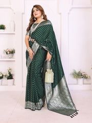 Woman wearing a green and silver saree with a white background