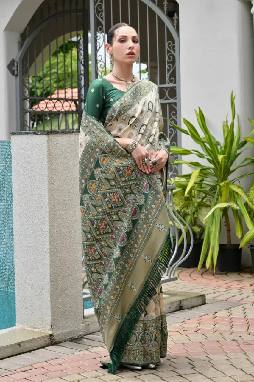 Elegant soft Banarasi silk saree in deep green shade featuring intricate zari border and pallu.