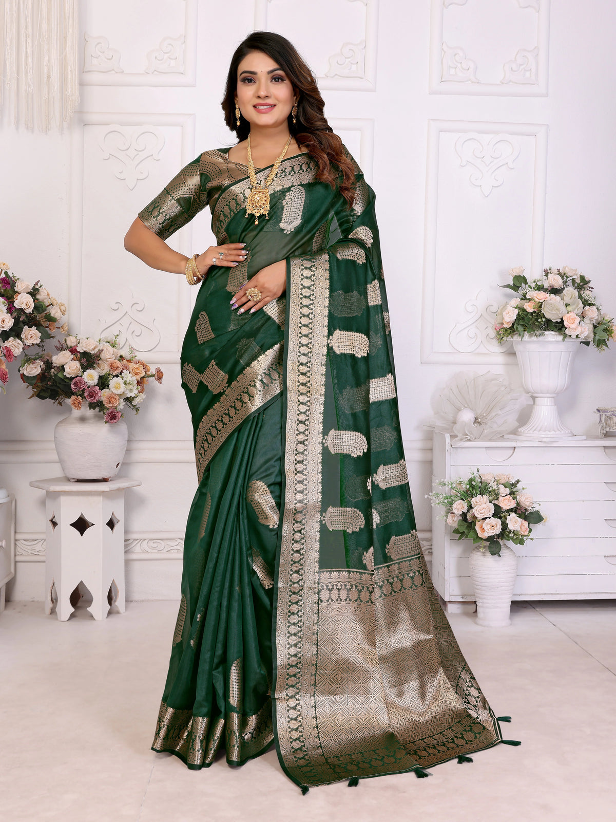 Woman wearing a green saree with a white background