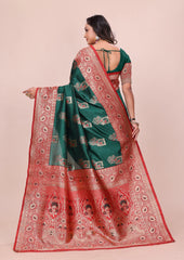 Woman wearing a green and red saree with a pattern on a beige background