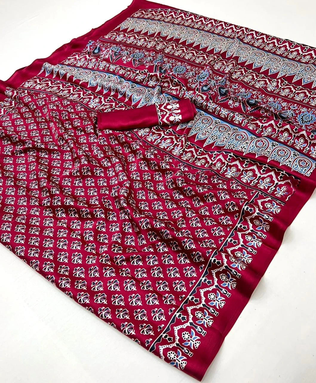 Red fabric with intricate patterns on a white background