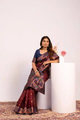 Woman in a traditional saree standing against a white background