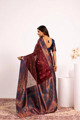 Woman wearing a traditional saree with a floral pattern on a white background