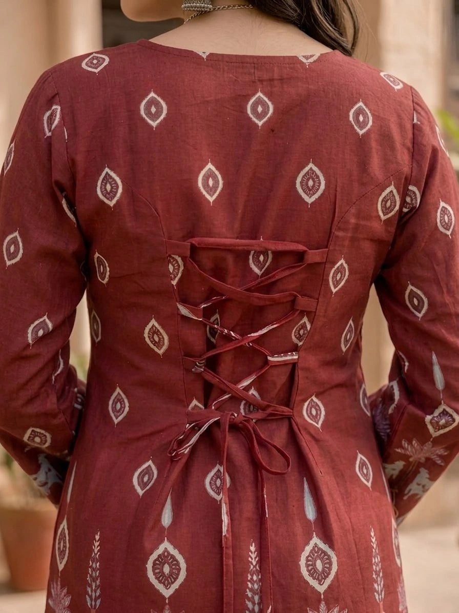 Red patterned kurta with a lace-up back, worn by a person.