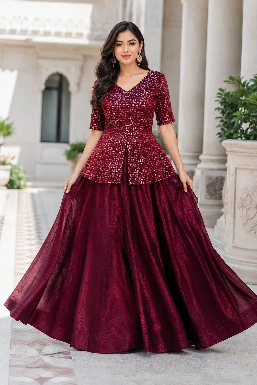 Woman wearing a burgundy evening gown with sequin top in an outdoor setting.