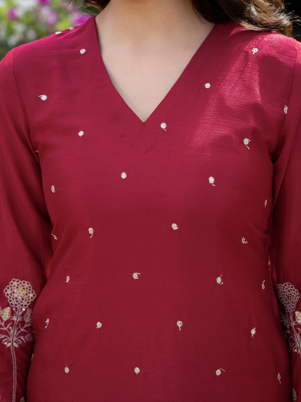Red kurta with white floral patterns worn by a person