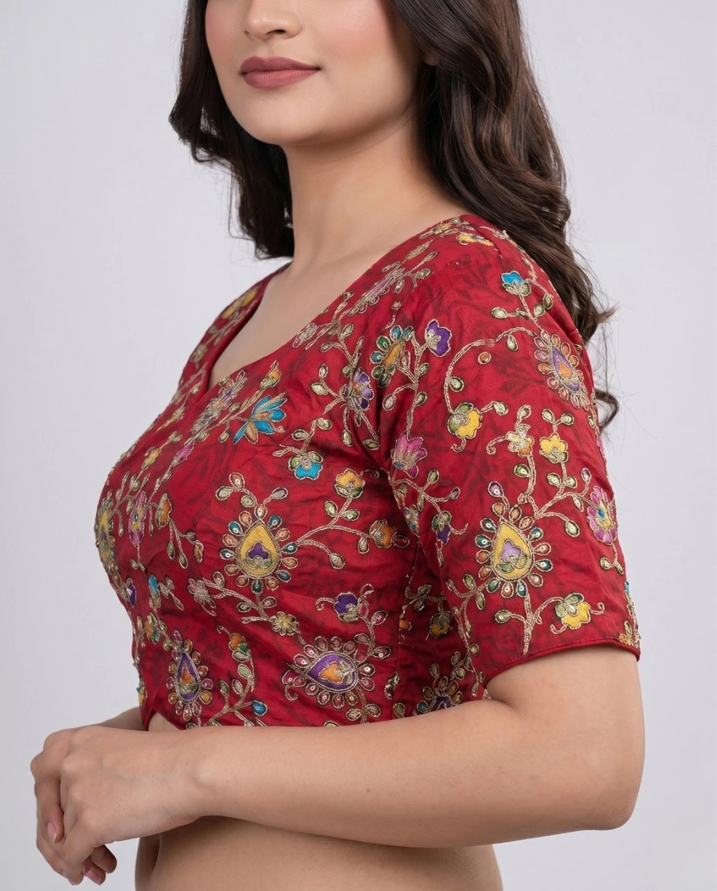 Red blouse with floral patterns on a plain background