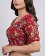 Red blouse with floral patterns on a plain background