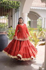 Premium Burnt Orange Party Wear Lehenga with Tiered Design, Golden Trim, and Graceful Traditional Look