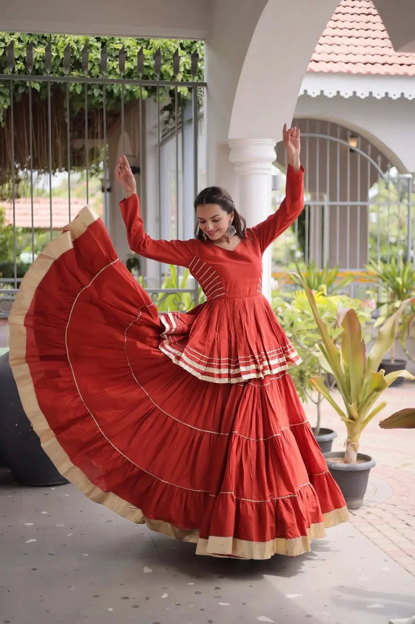 Traditional Rust Orange Lehenga Outfit with Peplum Kurti, Broad Ghera, and Classic Golden Lace Work