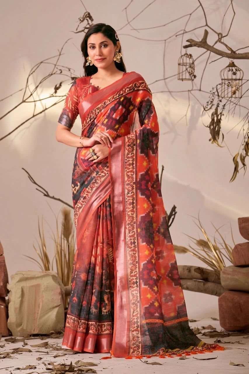 Woman wearing a red and black patterned saree with a neutral background
