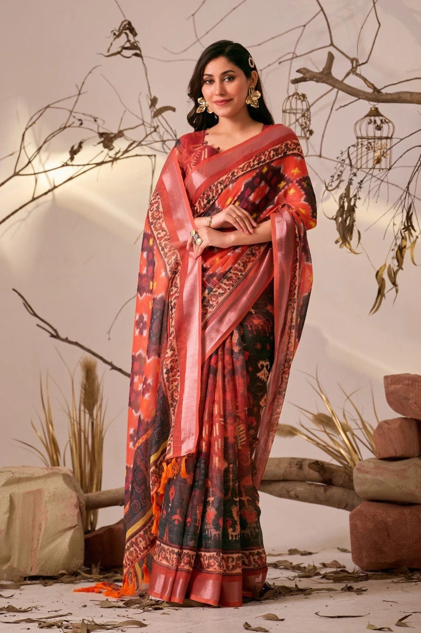 Woman wearing a red and black saree with a pattern, standing against a neutral background.