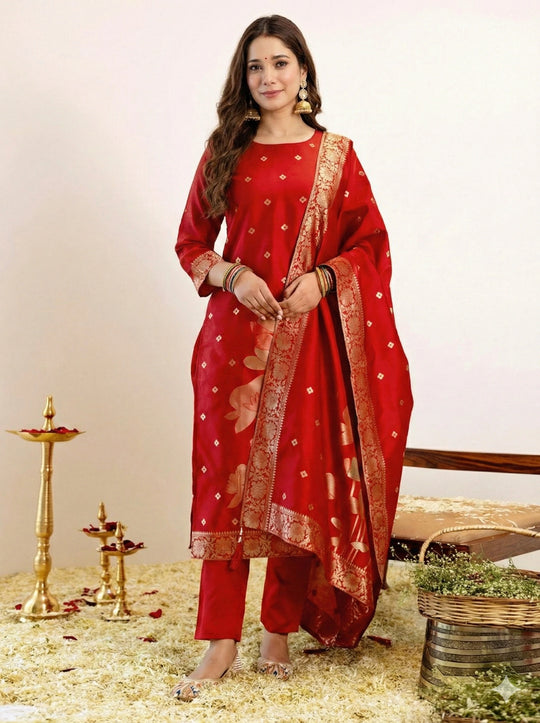 Woman wearing a red traditional outfit with gold details on a neutral background
