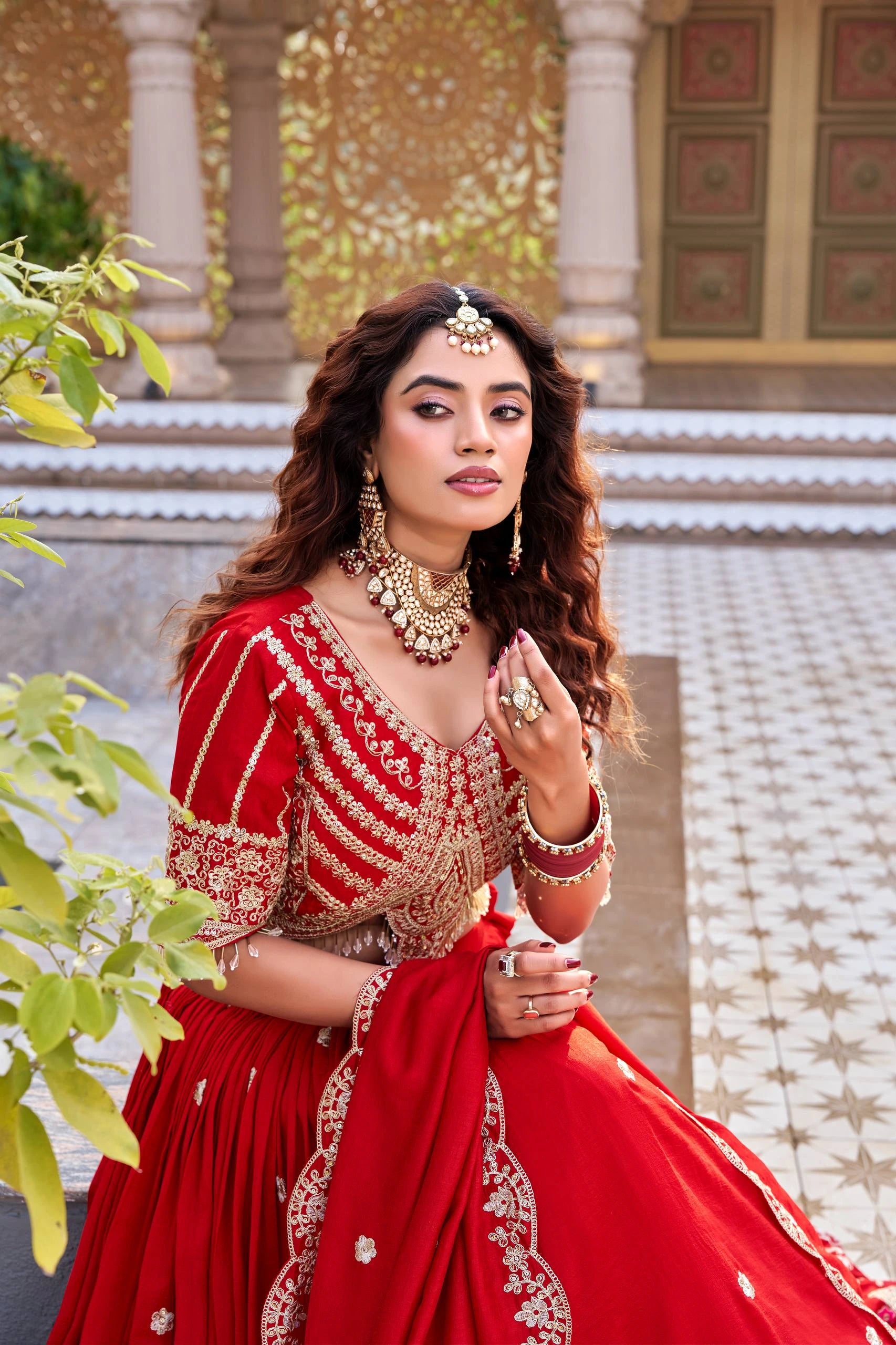 Traditional Indian bridal lehenga in dark pastel red with shimmering sequins showcased online