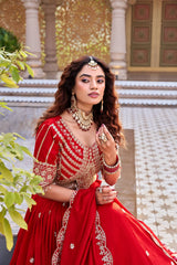 Traditional Indian bridal lehenga in dark pastel red with shimmering sequins showcased online