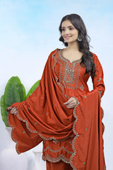 Woman wearing a red traditional outfit with intricate embroidery against a white background