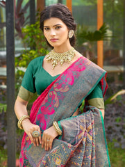 Woman wearing a traditional saree with a green blouse in an outdoor setting