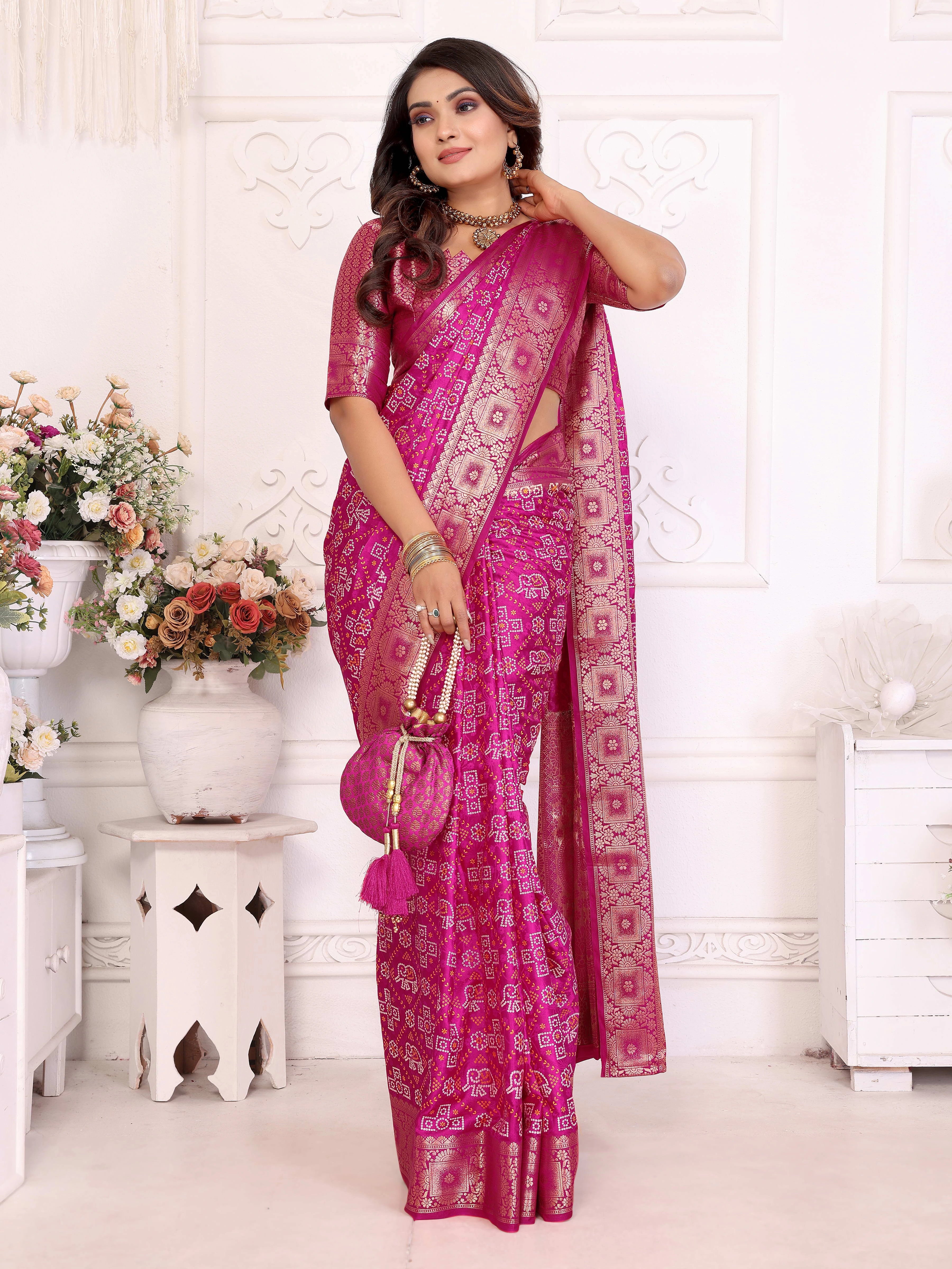 Woman wearing a pink saree with a white background