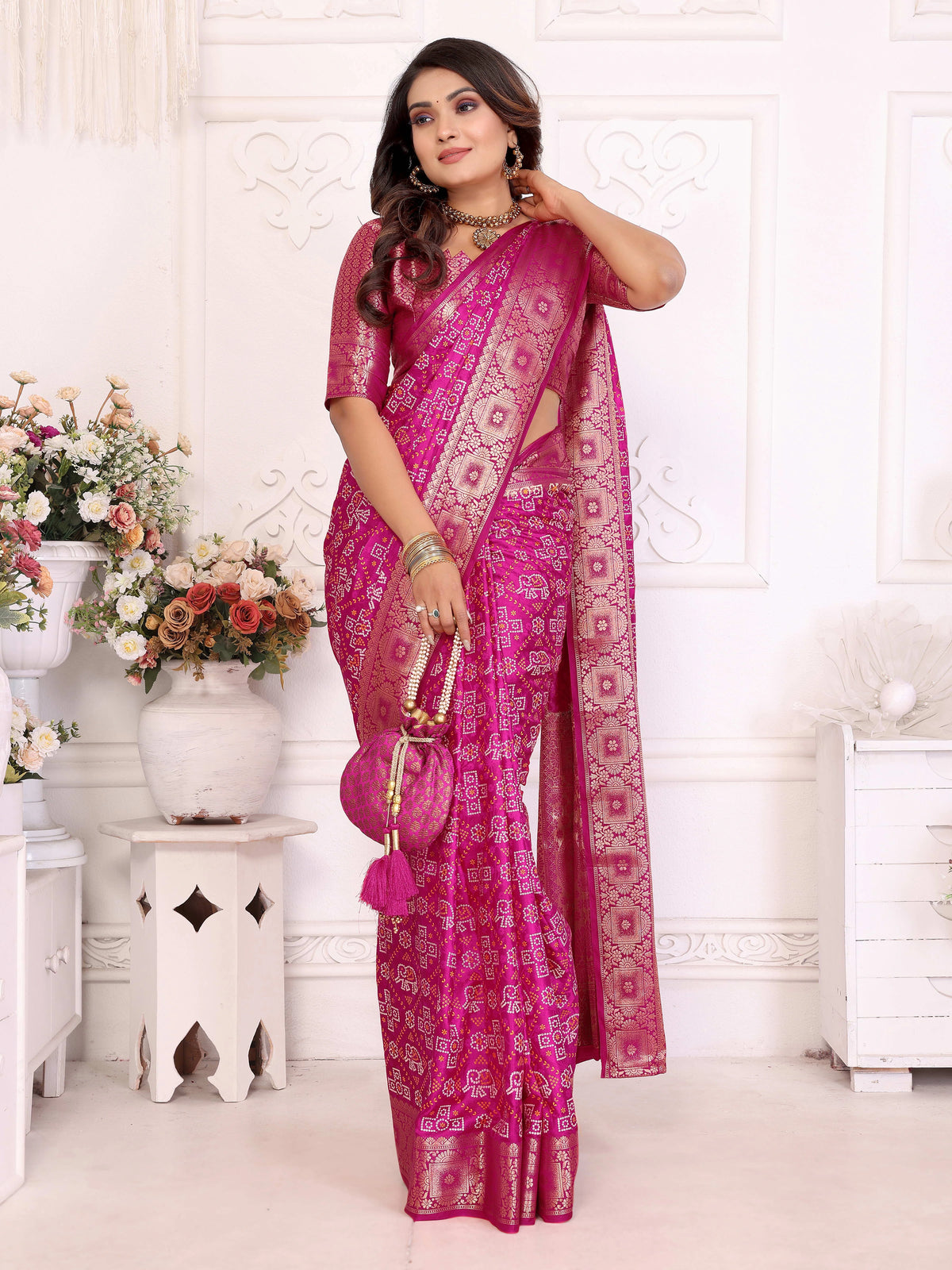 Woman wearing a pink saree with a white background