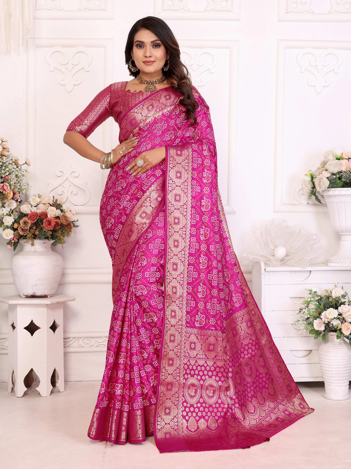 Woman wearing a pink saree with a white background