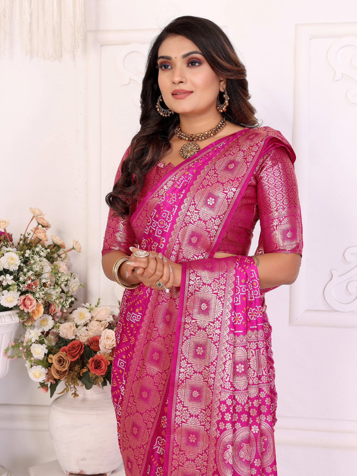 Woman wearing a pink saree with a white background