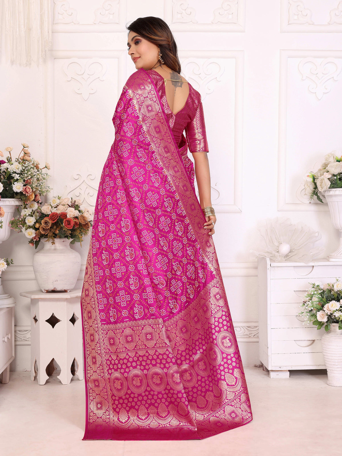 Woman wearing a pink saree with a white background
