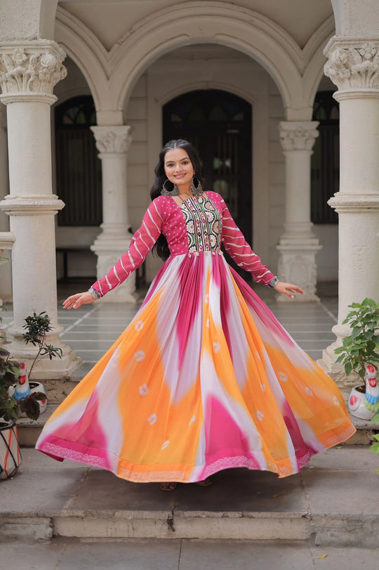 Woman in a colorful dress standing in an architectural setting with columns.